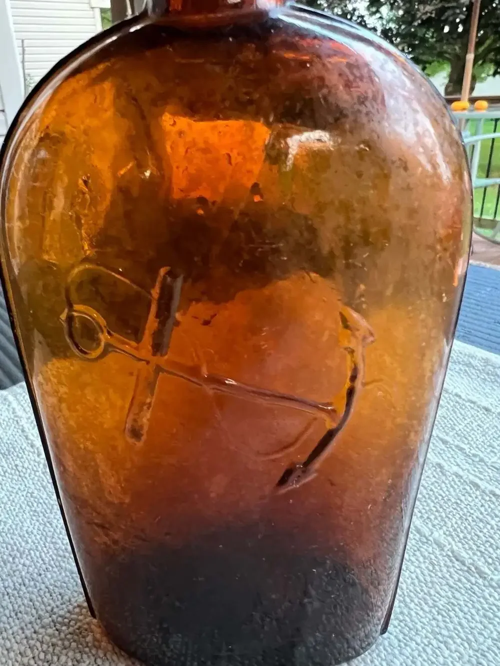 Antique Amber Glass Strap-Sided Whiskey Flask with Embossed Anchor